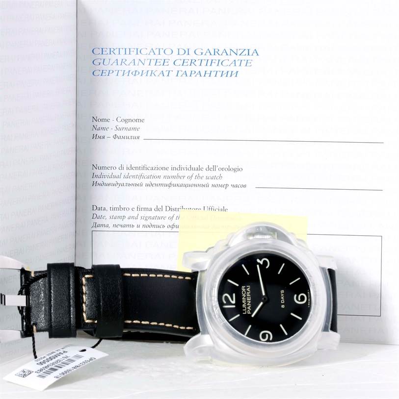 The image shows a Panerai Luminor PAM00560 Men
s Stainless Steel Black Dial PAM00560 Men
s Stainless Steel Black Dial model watch with protective cover and black leather strap in front of its guarantee certificate.