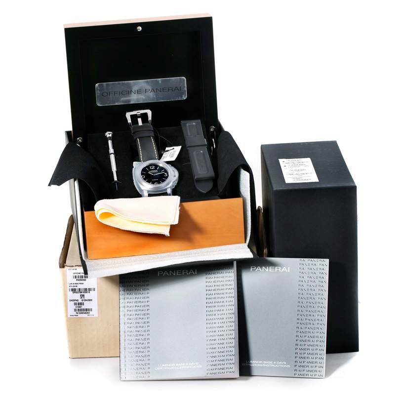The image shows a Panerai Luminor PAM00560 Men
s Stainless Steel Black Dial PAM00560 Men
s Stainless Steel Black Dial watch from a front angle, along with its box, extra strap, tools, and manuals.