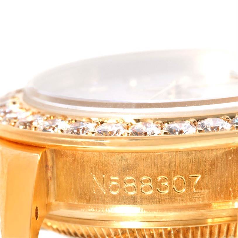 This close-up shot of the Rolex Pearlmaster 69298 Women's Yellow Gold Mother of Pearl Dial 69298 Women's Yellow Gold Mother of Pearl Dial watch shows a partial view of the gold case with diamonds and a serial number engraving.