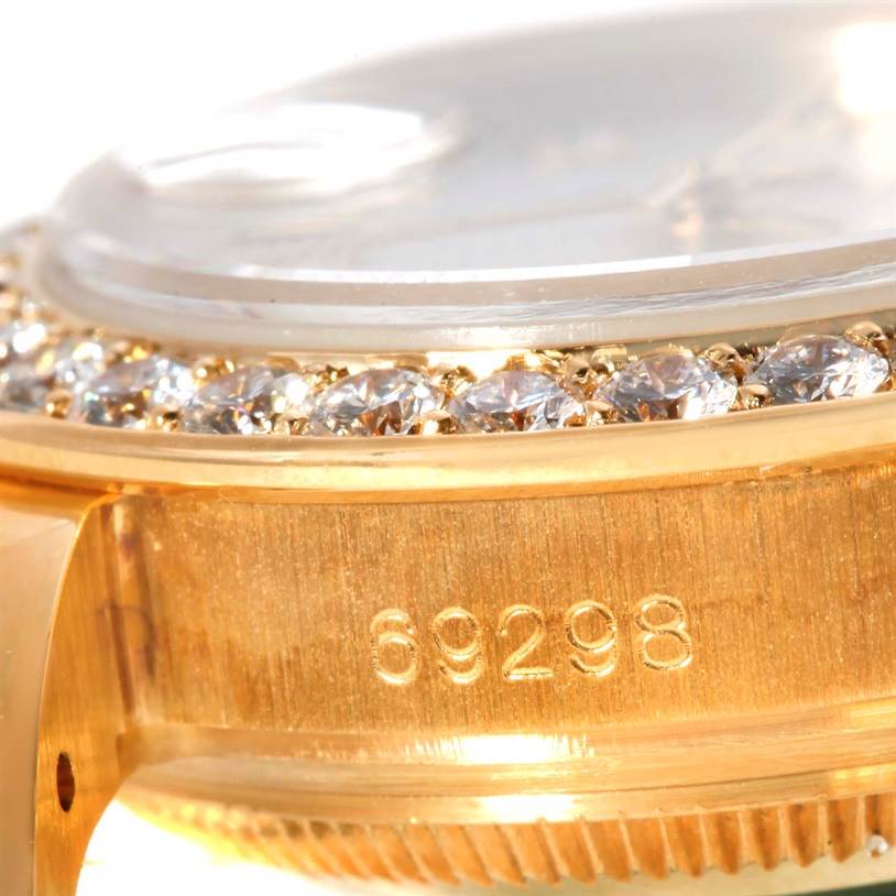 This close-up of the Rolex Pearlmaster 69298 Women's Yellow Gold Mother of Pearl Dial 69298 Women's Yellow Gold Mother of Pearl Dial watch shows the side view of the case with diamond detailing and the model number 69298.