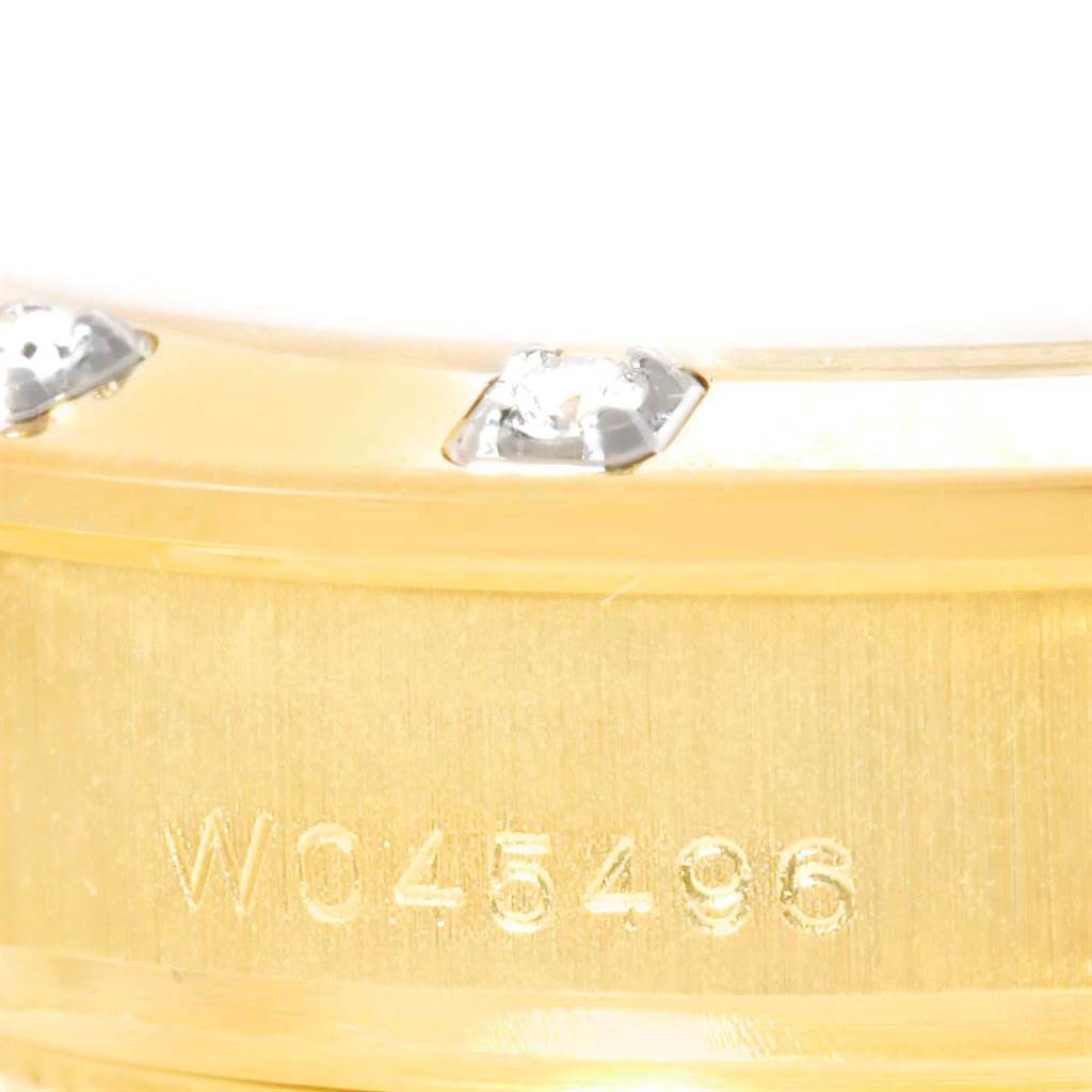 This image shows a close-up angle of the bezel and case of a Rolex Pearlmaster 69318 Women's Yellow Gold White Dial 69318 Women's Yellow Gold White Dial watch, featuring diamond accents and the serial number.