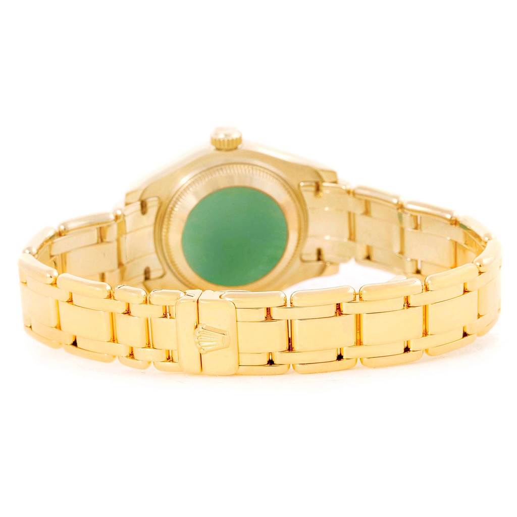 The image shows the rear view of a Rolex Pearlmaster 69318 Women's Yellow Gold White Dial 69318 Women's Yellow Gold White Dial watch, highlighting its gold bracelet and case back.