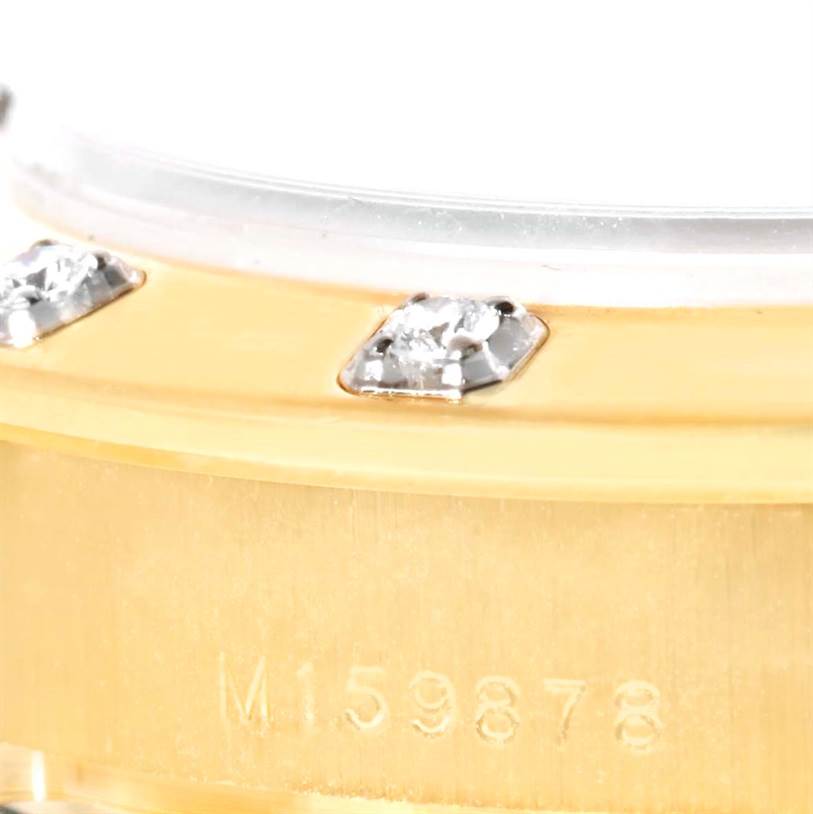 This close-up angle shows the side of the Rolex Pearlmaster 80318 Women's Yellow Gold Mother of Pearl Dial 80318 Women's Yellow Gold Mother of Pearl Dial's bezel with diamond settings and part of its case with engravings.