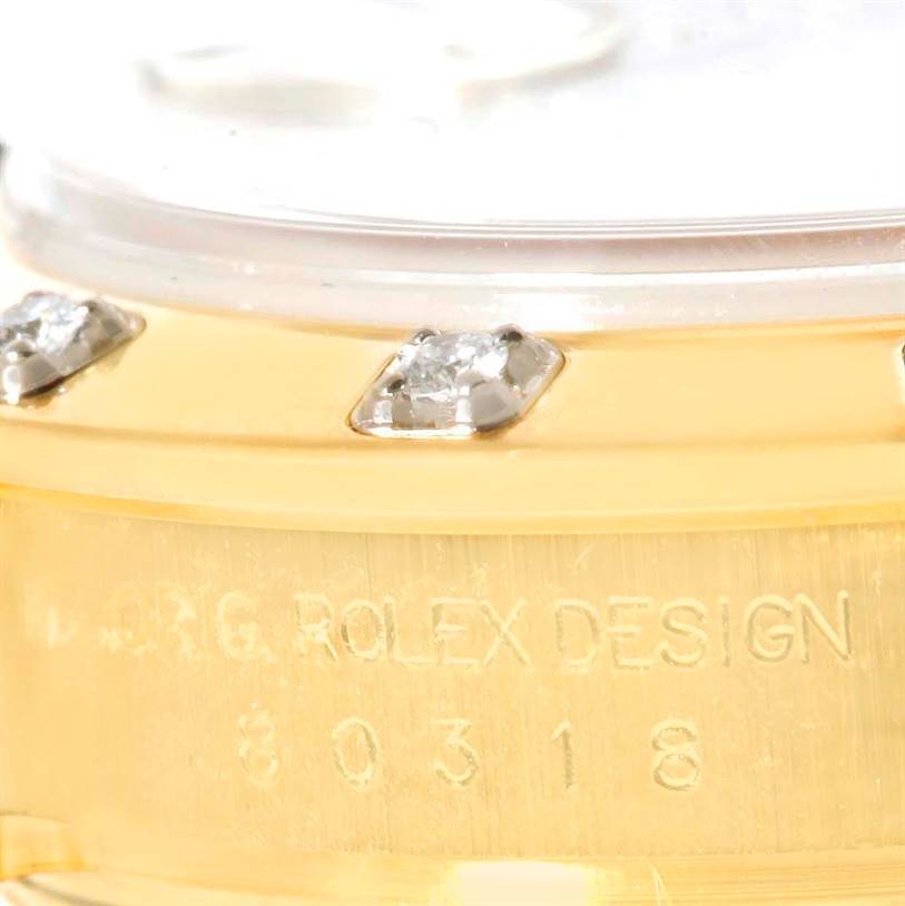 The image shows a close-up angle of the bezel and the partially revealed serial number on the Pearlmaster model by Rolex.