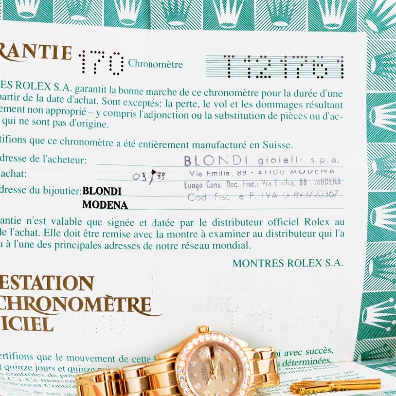 The image shows the Rolex Pearlmaster 69298 Women's Yellow Gold Champagne Dial 69298 Women's Yellow Gold Champagne Dial watch partially, positioned at the bottom, with a guarantee certificate in the background.