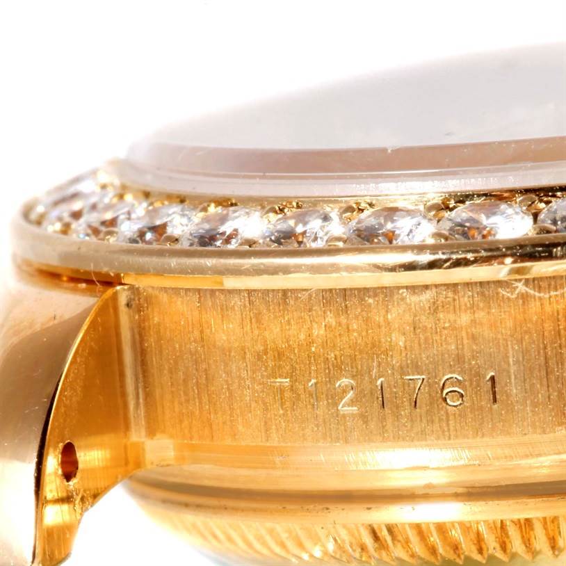 The image shows a close-up side view of the Rolex Pearlmaster 69298 Women's Yellow Gold Champagne Dial 69298 Women's Yellow Gold Champagne Dial watch casing with diamond embellishments and part of the serial number.