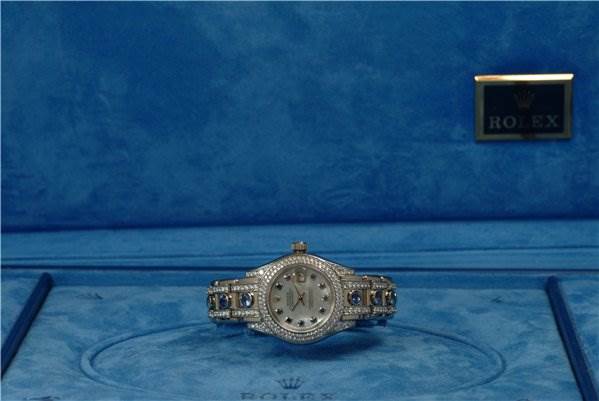 The Rolex Pearlmaster 80359 Women's White Gold Mother of Pearl Dial 80359 Women's White Gold Mother of Pearl Dial watch is shown from the front, displaying its face and diamond-encrusted band.