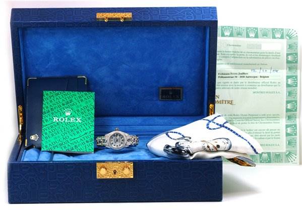 The Rolex Pearlmaster 80359 Women's White Gold Mother of Pearl Dial 80359 Women's White Gold Mother of Pearl Dial watch is displayed inside an open blue case, alongside accessories, manuals, and documents.