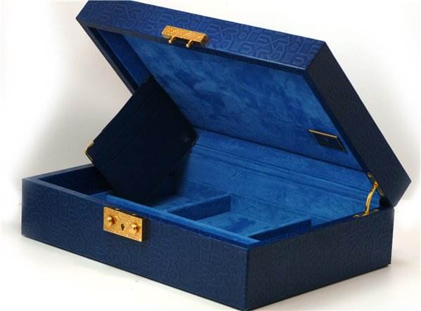 The image shows a blue Rolex Pearlmaster 80359 Women's White Gold Mother of Pearl Dial 80359 Women's White Gold Mother of Pearl Dial watch box with golden clasps, open to reveal compartments inside.