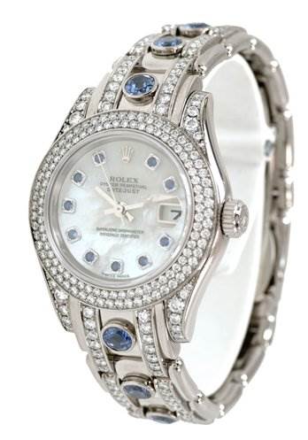 The Rolex Pearlmaster 80359 Women's White Gold Mother of Pearl Dial 80359 Women's White Gold Mother of Pearl Dial watch is shown at an angled side view, highlighting its face, bezel, and gemstone-adorned bracelet.