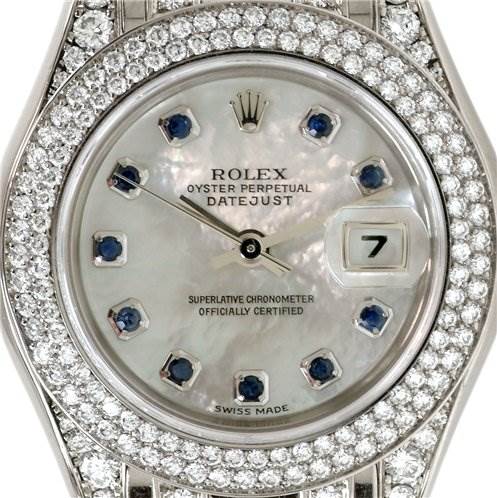 The image shows a close-up of the face of a Rolex Pearlmaster 80359 Women's White Gold Mother of Pearl Dial 80359 Women's White Gold Mother of Pearl Dial watch, featuring its dial, hands, and bejeweled bezel.