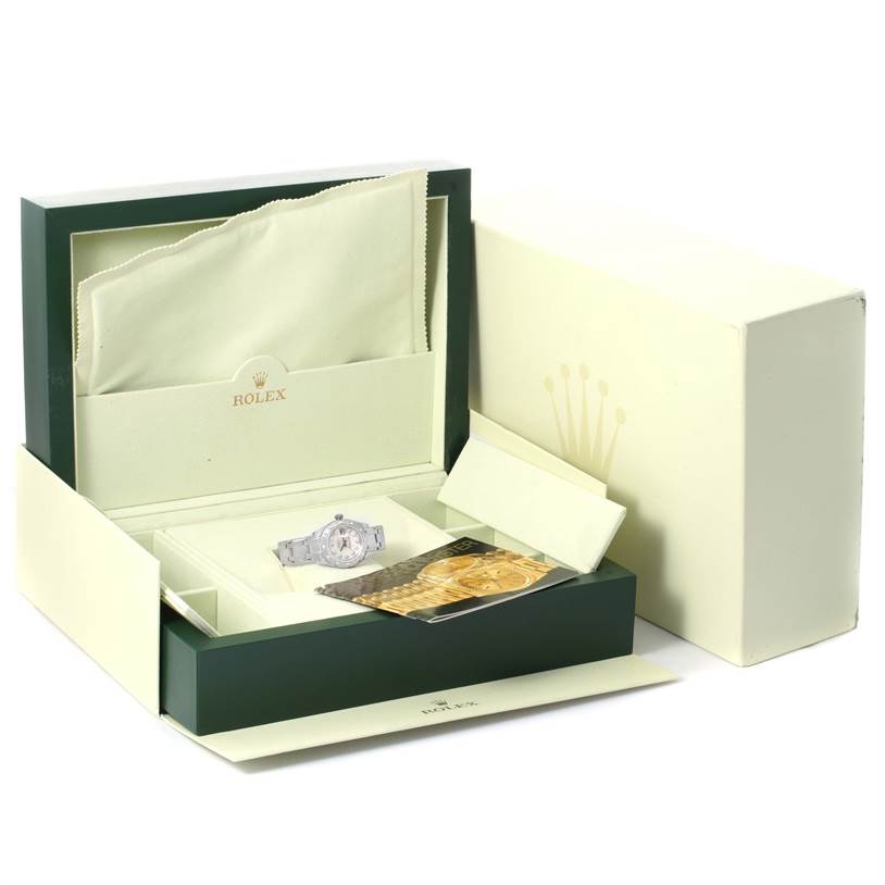 The Rolex Pearlmaster 80319 Women's White Gold Mother of Pearl Dial 80319 Women's White Gold Mother of Pearl Dial watch is shown inside an open box, along with a card and cleaning cloth.