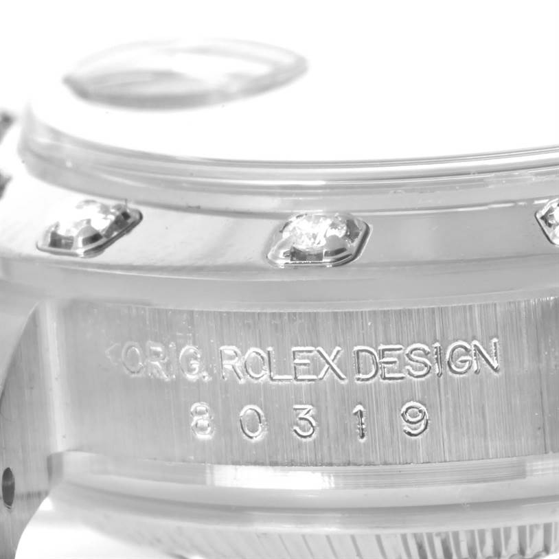 The image shows a close-up of the side of a Rolex Pearlmaster 80319 Women's White Gold Mother of Pearl Dial 80319 Women's White Gold Mother of Pearl Dial watch, highlighting diamond details and the engraved text.