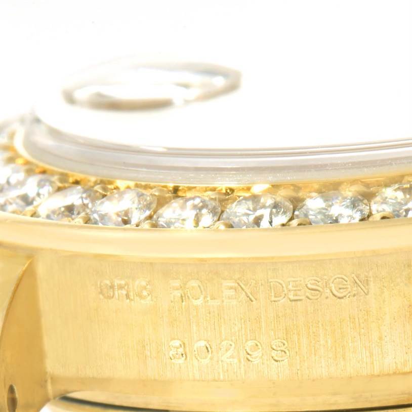 This close-up image features the diamond bezel and engraved side of a Rolex Pearlmaster 80298 Women's Yellow Gold Champagne Dial 80298 Women's Yellow Gold Champagne Dial watch.