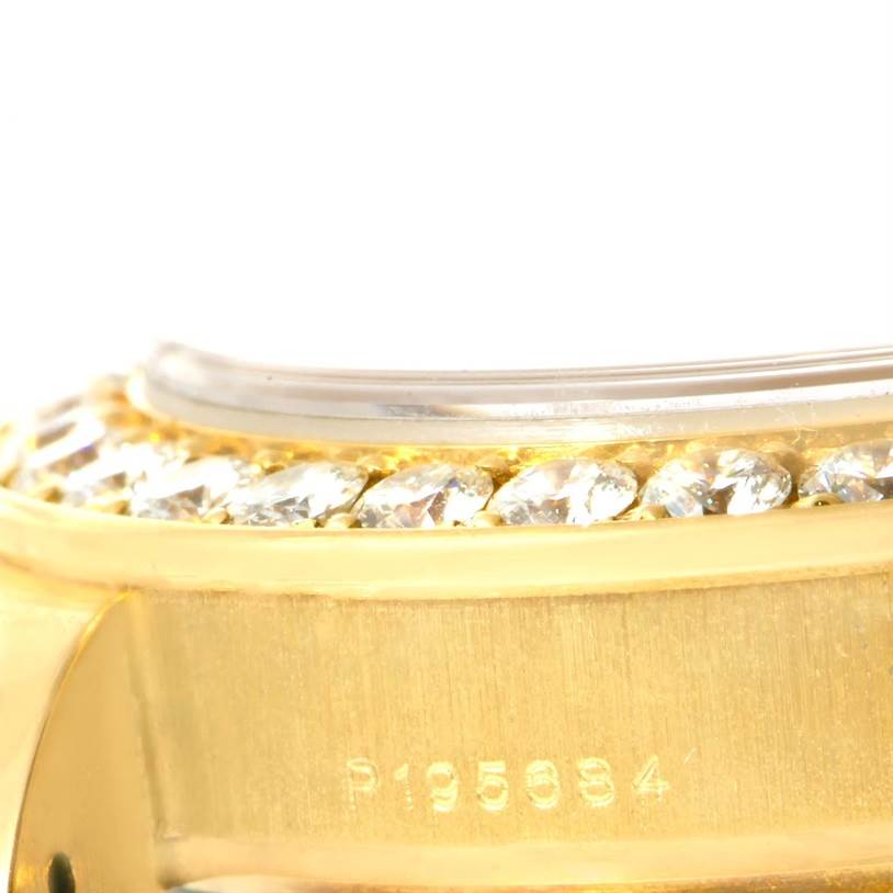 The image shows a close-up of the bezel and part of the case of a Rolex Pearlmaster 80298 Women's Yellow Gold Champagne Dial 80298 Women's Yellow Gold Champagne Dial watch, showcasing diamonds and a serial number.