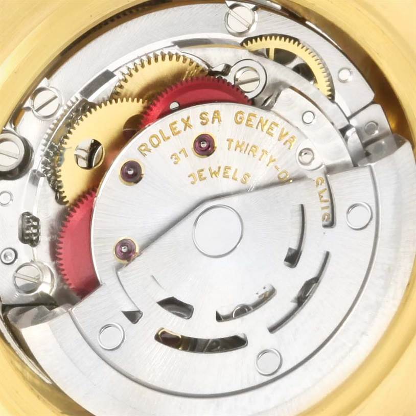This image shows the internal mechanism of the Rolex Pearlmaster 80298 Women's Yellow Gold Champagne Dial 80298 Women's Yellow Gold Champagne Dial watch, highlighting its gears and the inscription on the movement.