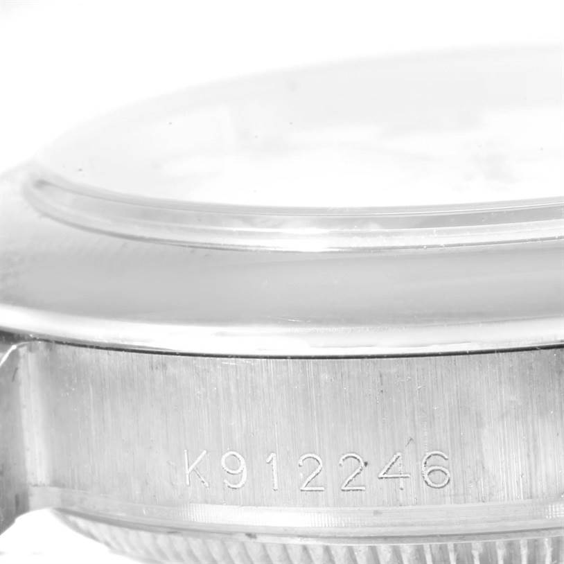 The image shows a close-up of the side view of a Rolex Pearlmaster 81209 Women's White Gold White Dial 81209 Women's White Gold White Dial watch case, highlighting the serial number.
