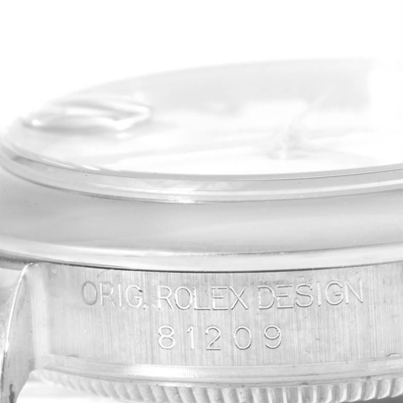 This image shows a close-up angle of the case side of a Rolex Pearlmaster 81209 Women's White Gold White Dial 81209 Women's White Gold White Dial, highlighting the engraved "ORIG. ROLEX DESIGN 81209."