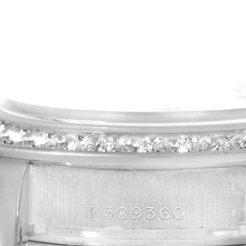 This close-up image shows the bezel and a portion of the case of a Rolex Pearlmaster 80299 Women's White Gold Mother of Pearl Dial 80299 Women's White Gold Mother of Pearl Dial watch, featuring diamond detailing and a serial number.