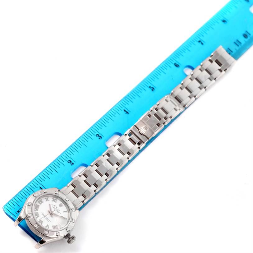 The image shows a Rolex Pearlmaster 80319 Women's White Gold White Dial 80319 Women's White Gold White Dial watch at a top-down angle, displaying the bracelet laid against a ruler for size reference.