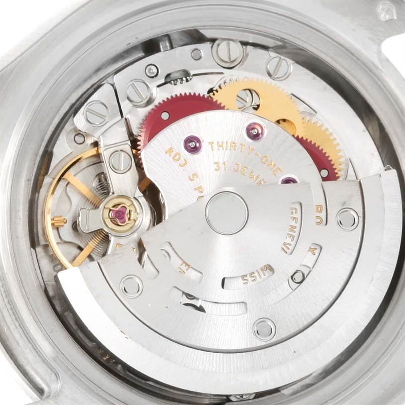 The image shows a close-up of the Rolex Pearlmaster 80319 Women's White Gold White Dial 80319 Women's White Gold White Dial watch's internal movement, highlighting gears and mechanical components.