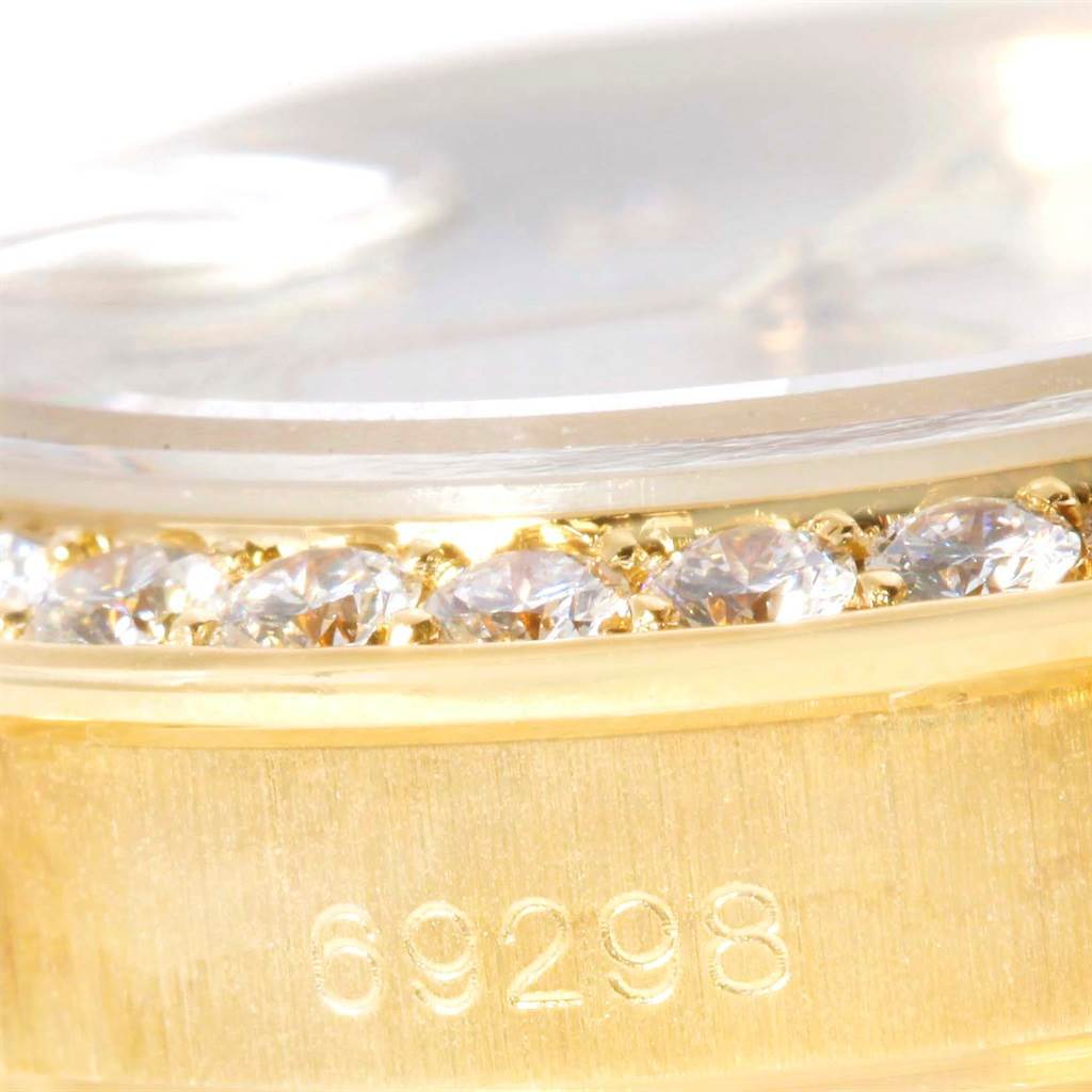 This close-up image shows the bezel with diamonds and part of the case of a Rolex Pearlmaster 69298 Women's Yellow Gold Mother of Pearl Dial 69298 Women's Yellow Gold Mother of Pearl Dial watch, along with the model number 69298.