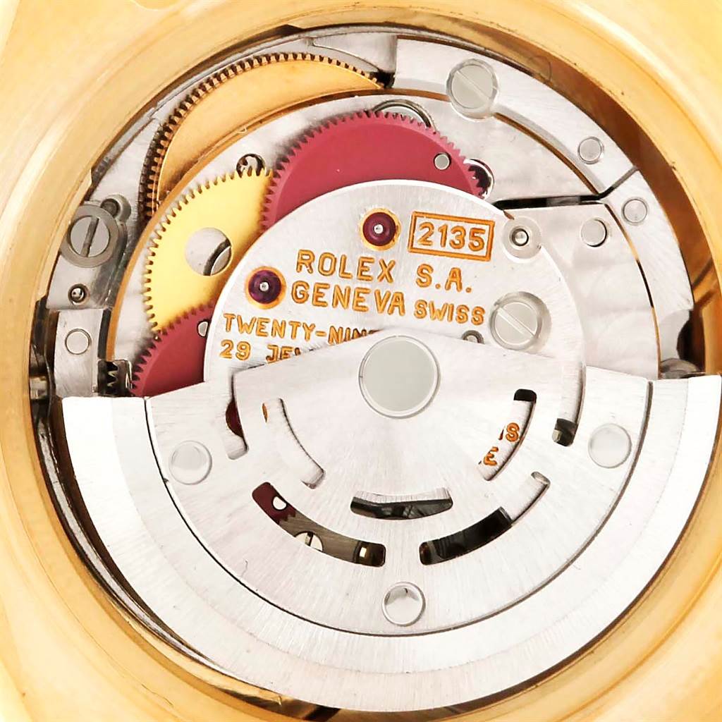 The image shows an internal view of the Rolex Pearlmaster 69298 Women's Yellow Gold Mother of Pearl Dial 69298 Women's Yellow Gold Mother of Pearl Dial watch, focusing on the movement and gears.