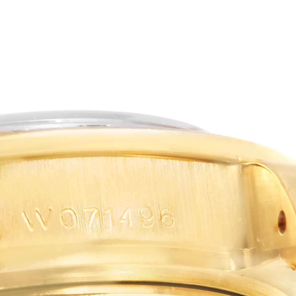 The image shows a close-up of the side of a Rolex Pearlmaster 69298 Women's Yellow Gold Champagne Dial 69298 Women's Yellow Gold Champagne Dial watch, highlighting the engraved serial number.