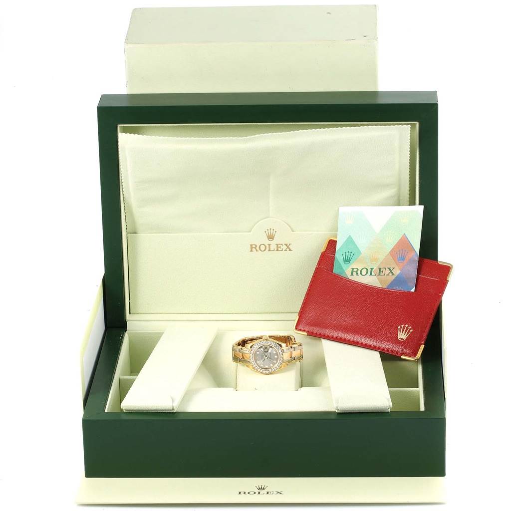 The Rolex Pearlmaster 80298 Women's Yellow Gold Silver Dial 80298 Women's Yellow Gold Silver Dial watch is shown in an open box with its certificate and cardholder.