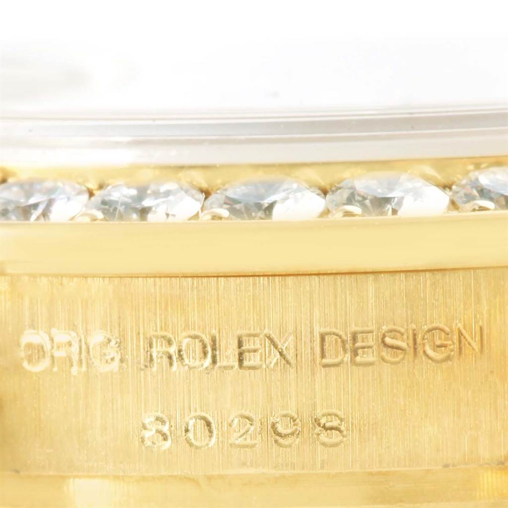 This image shows a close-up of the bezel and side of a Rolex Pearlmaster 80298 Women's Yellow Gold Silver Dial 80298 Women's Yellow Gold Silver Dial watch, highlighting the diamonds and model numbers.