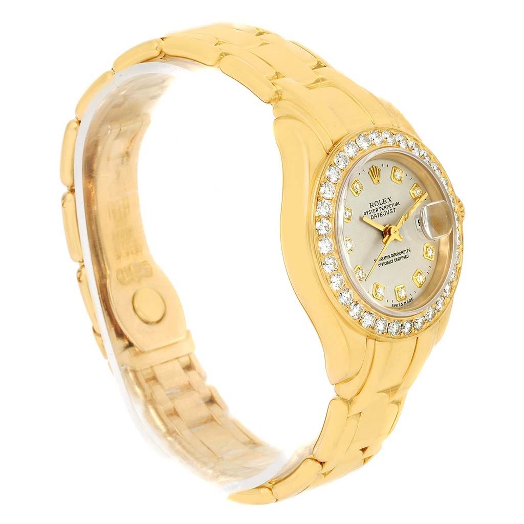 This image displays a Rolex Pearlmaster 69298 Women's Yellow Gold Silver Dial 69298 Women's Yellow Gold Silver Dial watch at a slight side angle, showcasing the face, diamond bezel, and part of the gold bracelet.