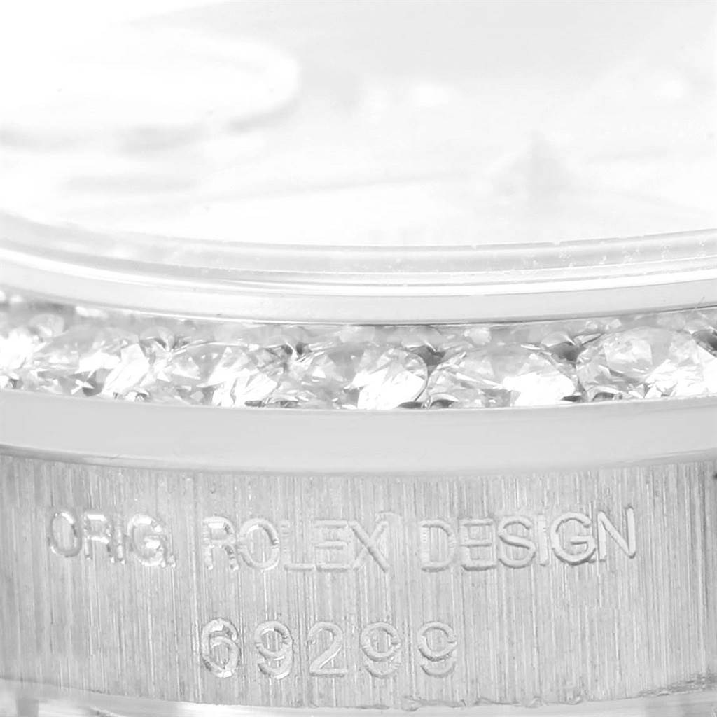 Close-up of a Rolex Pearlmaster 69298 Women's White Gold Mother of Pearl Dial 69298 Women's White Gold Mother of Pearl Dial model watch showing the side of the bezel with embedded diamonds and the engraved model number 69299.