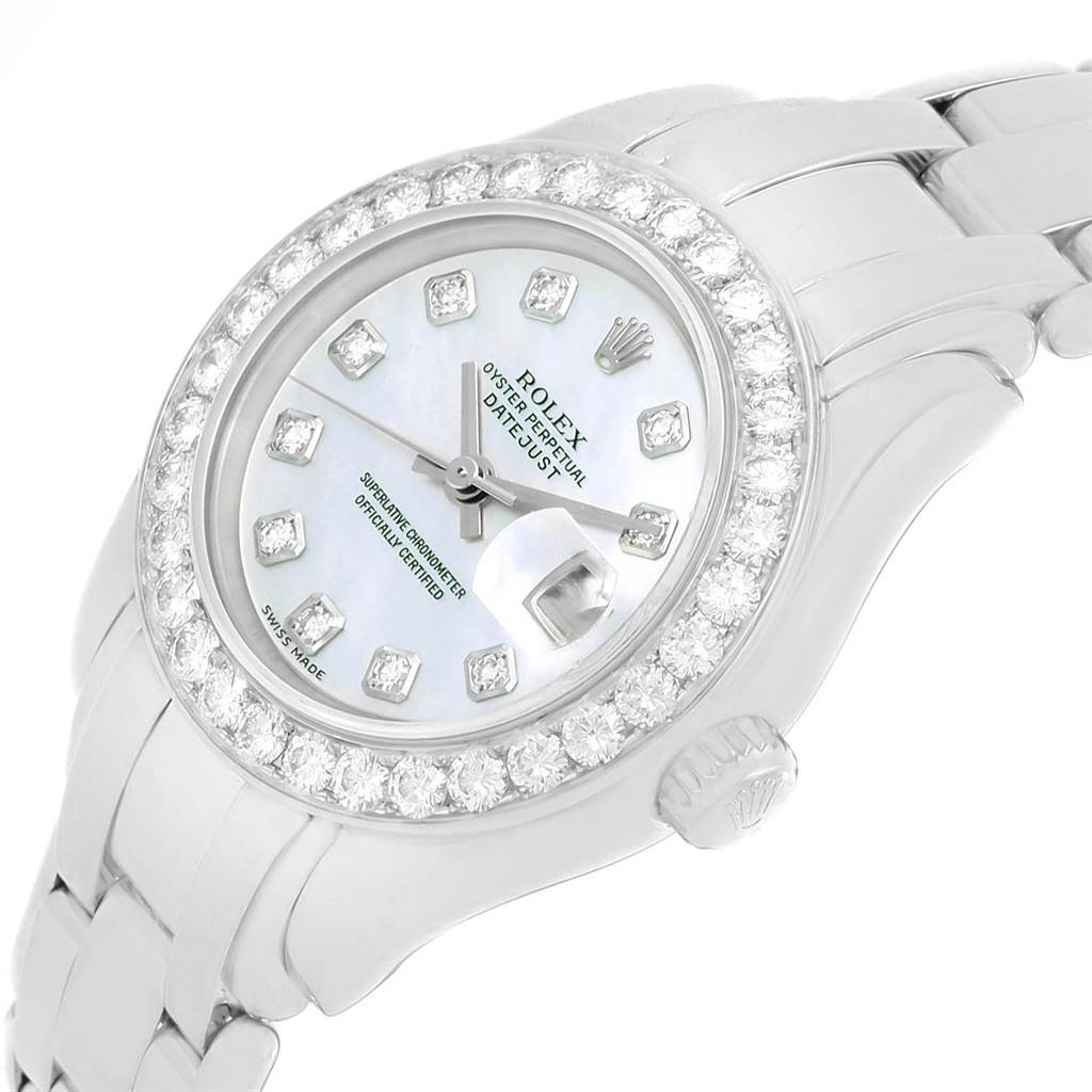 The image shows a close-up, angled view of a Rolex Pearlmaster 69298 Women's White Gold Mother of Pearl Dial 69298 Women's White Gold Mother of Pearl Dial watch featuring a diamond-studded bezel and a mother-of-pearl dial.