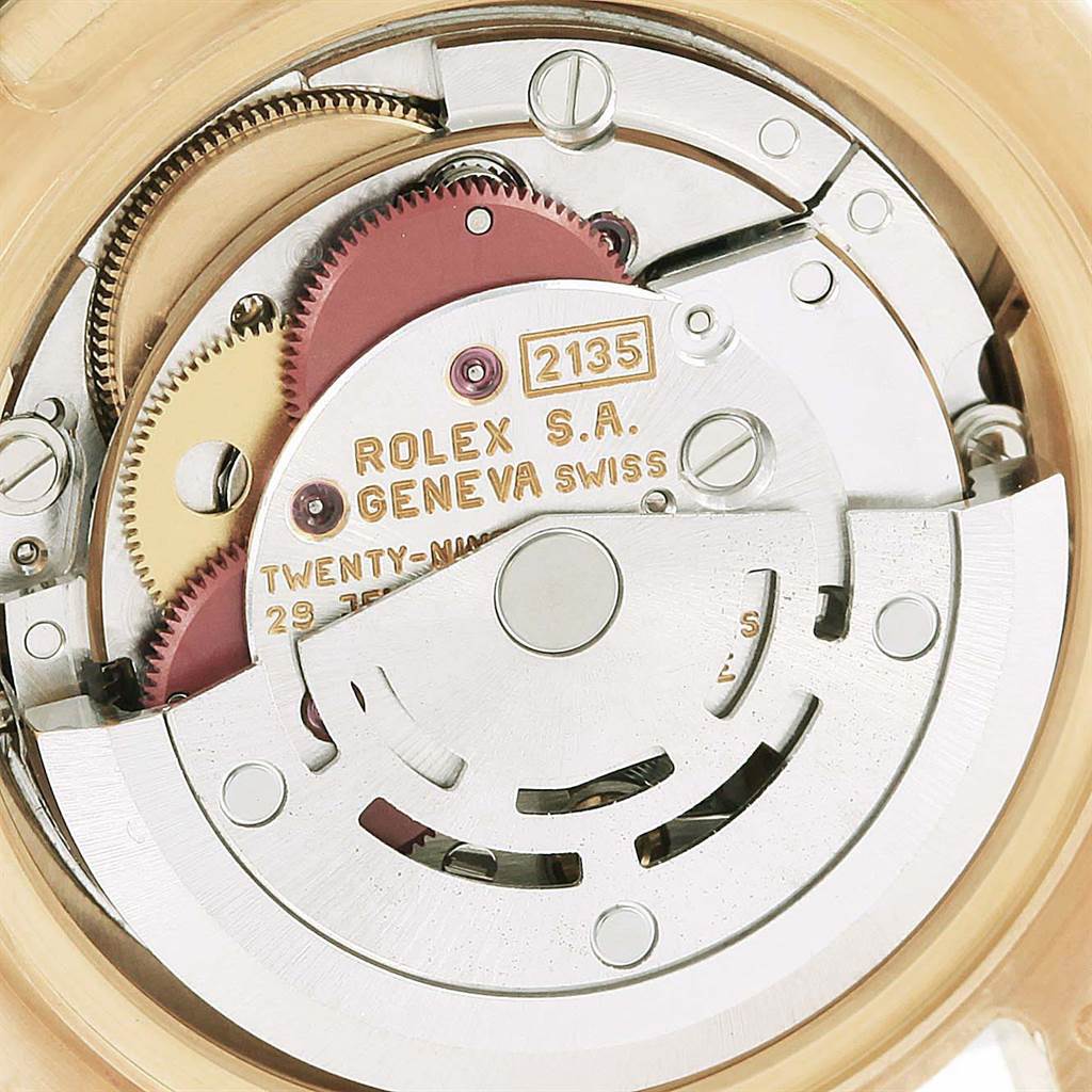 This image shows a close-up of the movement mechanism of a Rolex Pearlmaster 69298 Women
s Yellow Gold Mother of Pearl Dial 69298 Women
s Yellow Gold Mother of Pearl Dial watch, focusing on the gears and the rotor.