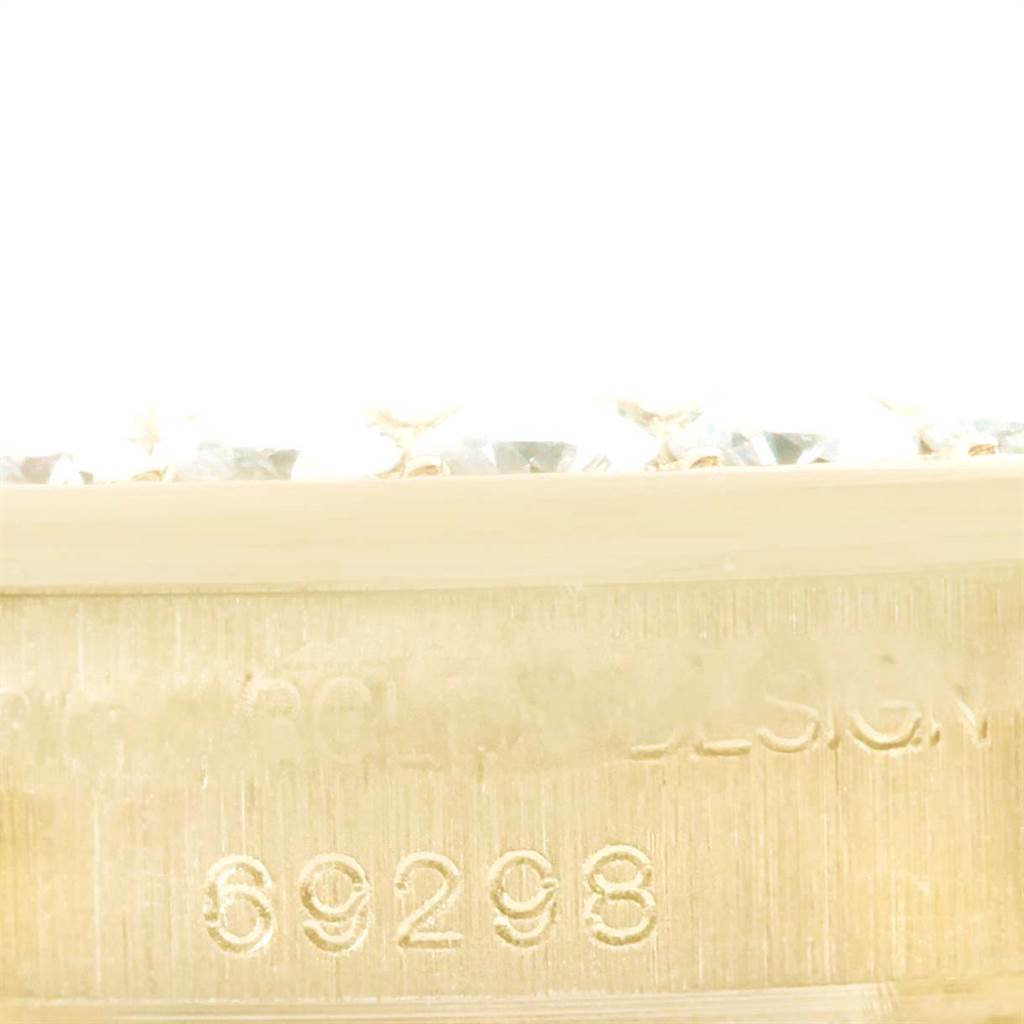 This close-up image shows the serial number and part of the bezel with diamonds on the Rolex Pearlmaster 69298 Women
s Yellow Gold Mother of Pearl Dial 69298 Women
s Yellow Gold Mother of Pearl Dial watch.