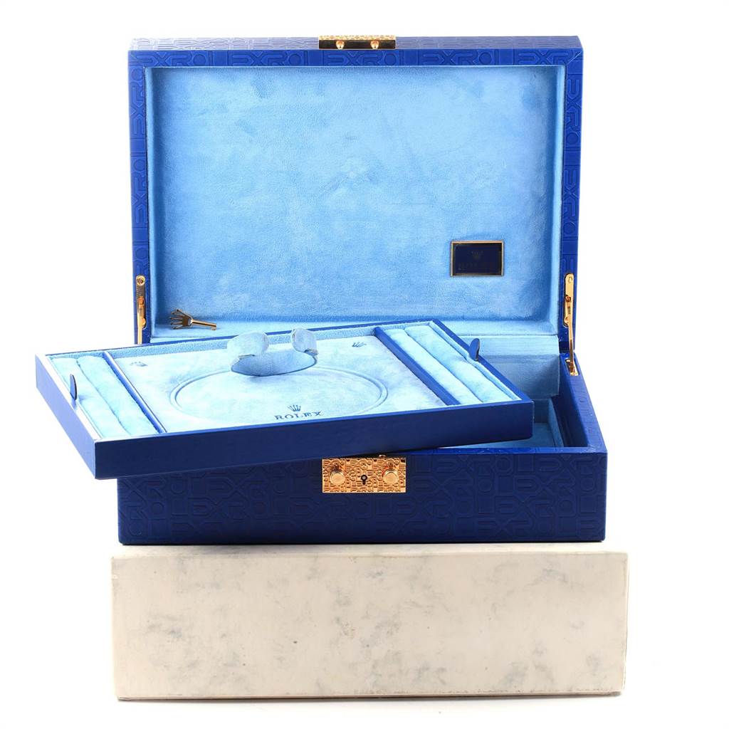 The image shows an open display box for a Rolex Pearlmaster 69298 Women
s Yellow Gold Mother of Pearl Dial 69298 Women
s Yellow Gold Mother of Pearl Dial watch, showcasing its blue interior and compartments from a front angle.