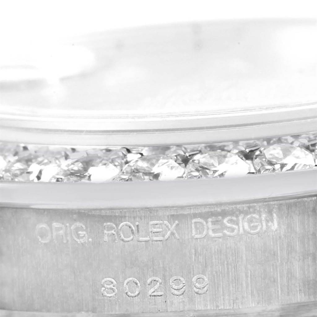 This close-up image shows the side view of the Rolex Pearlmaster 80299 Women's White Gold Mother of Pearl Dial 80299 Women's White Gold Mother of Pearl Dial's diamond-set bezel and case design with the model number engraved.