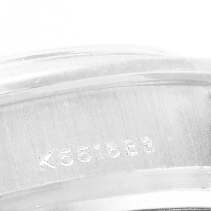 This close-up image shows the engraved serial number on the casing of a Rolex Pearlmaster 80299 Women's White Gold White Dial 80299 Women's White Gold White Dial watch.