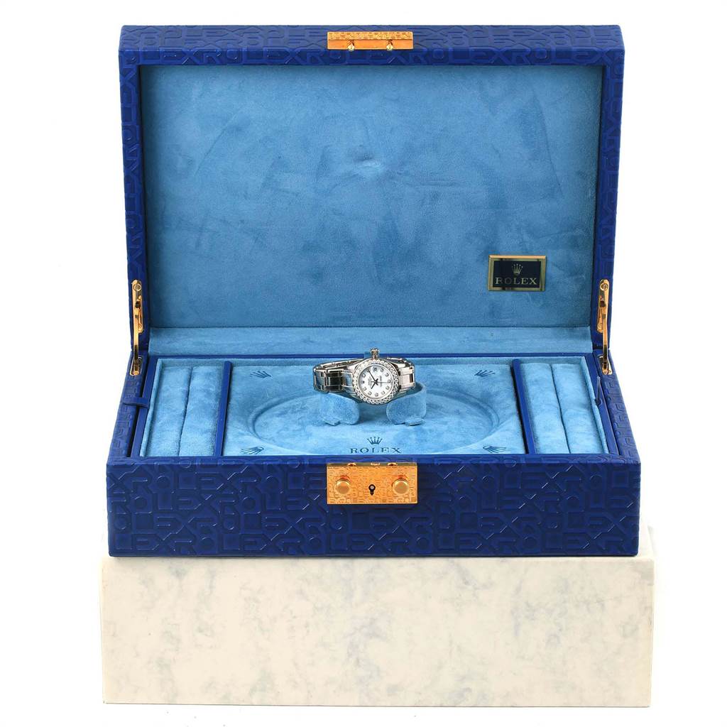 The Rolex Pearlmaster 80299 Women's White Gold White Dial 80299 Women's White Gold White Dial watch is shown front-facing in an open blue display box.
