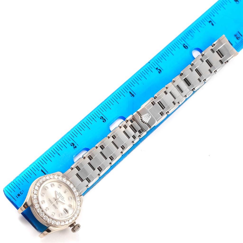 This image shows a Rolex Pearlmaster 80299 Women
s White Gold Mother of Pearl Dial 80299 Women
s White Gold Mother of Pearl Dial watch laid flat next to a blue ruler, highlighting the watch face and bracelet.