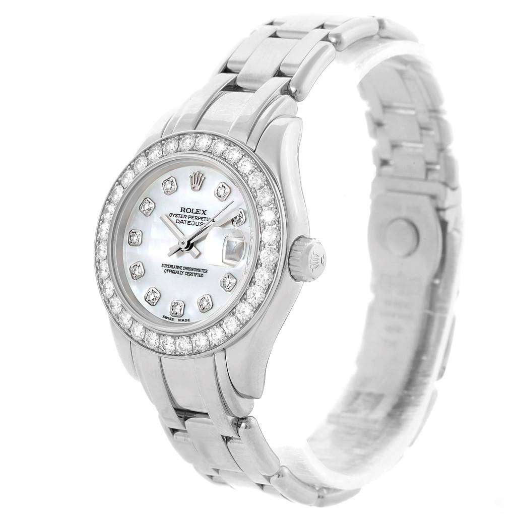The Rolex Pearlmaster 80299 Women
s White Gold Mother of Pearl Dial 80299 Women
s White Gold Mother of Pearl Dial watch is shown from an oblique angle, highlighting its diamond-studded bezel, dial, and metal bracelet.