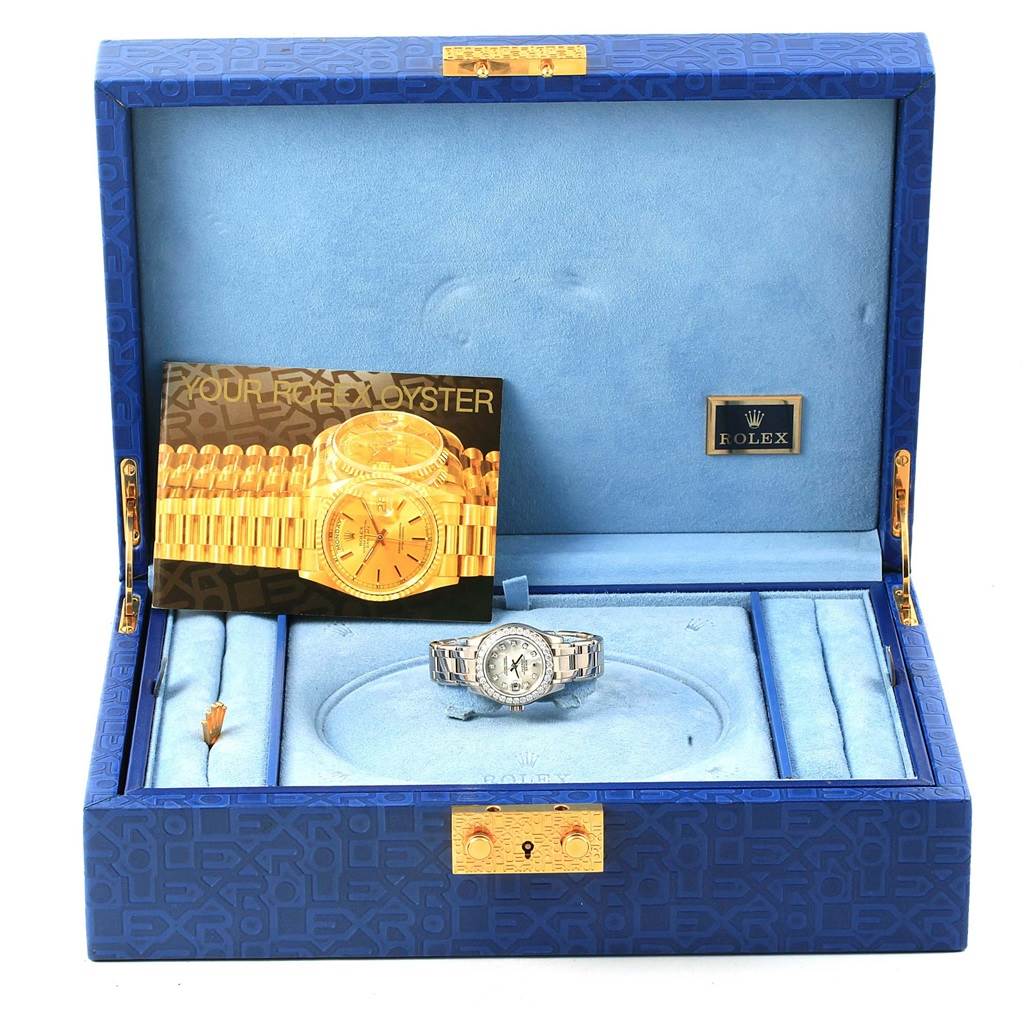 This image shows a Rolex Pearlmaster 80299 Women
s White Gold Mother of Pearl Dial 80299 Women
s White Gold Mother of Pearl Dial watch in its open box, along with a booklet and accessories.