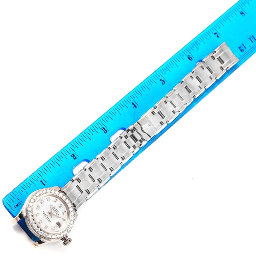 The image shows the Rolex Pearlmaster 80299 Women
s White Gold Mother of Pearl Dial 80299 Women
s White Gold Mother of Pearl Dial watch laid flat, with the full bracelet and face visible alongside a blue ruler for measurement.