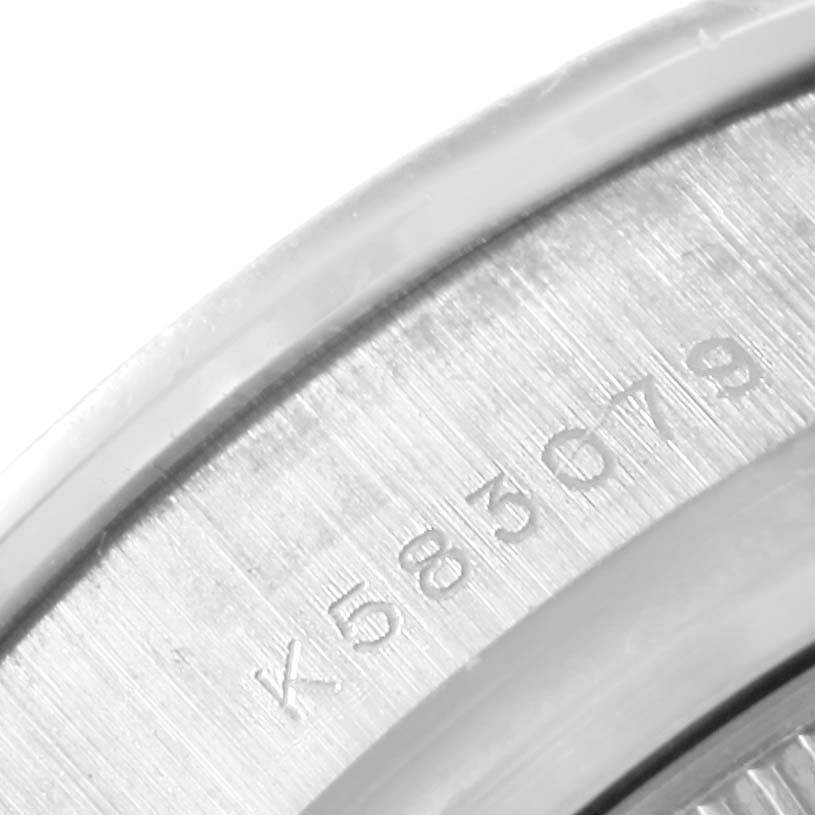 This close-up image of the Rolex Pearlmaster 80299 Women
s White Gold Mother of Pearl Dial 80299 Women
s White Gold Mother of Pearl Dial watch displays the edge of the bezel and part of the inner case with engraved markings.