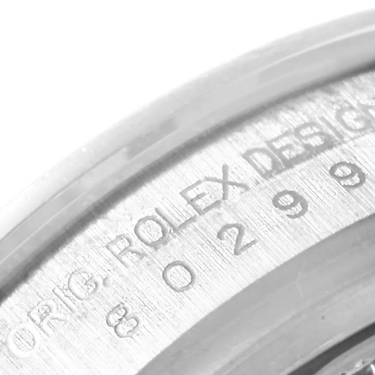 This image shows a close-up angle of the engraved serial number and "ROLEX DESIGN" text on the Rolex Pearlmaster 80299 Women
s White Gold Mother of Pearl Dial 80299 Women
s White Gold Mother of Pearl Dial model.