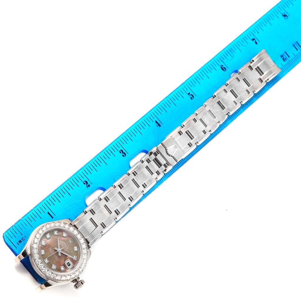 This image shows a Rolex Pearlmaster 80299 Women
s White Gold Mother of Pearl Dial 80299 Women
s White Gold Mother of Pearl Dial watch placed alongside a ruler, highlighting both the face and bracelet.