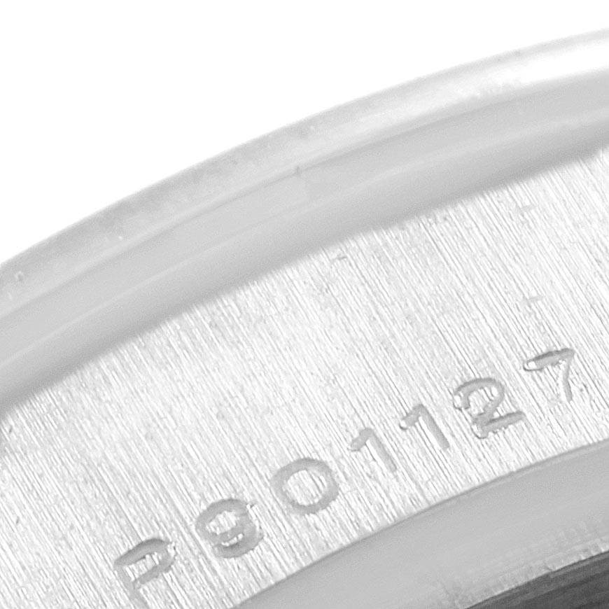 This image shows a close-up of the serial number engraving on a Rolex Pearlmaster 80299 Women's White Gold Mother of Pearl Dial 80299 Women's White Gold Mother of Pearl Dial watch.
