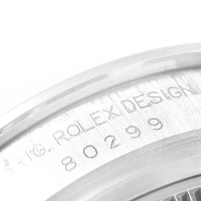 This image shows a close-up of the casing with the engraving "ROLEX DESIGN 80299" on a Rolex Pearlmaster 80299 Women's White Gold White Dial 80299 Women's White Gold White Dial watch.