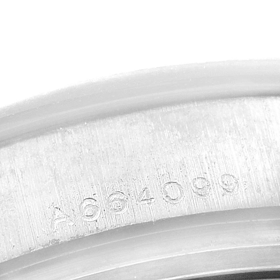 This image shows a close-up of the serial number engraving on the case of a Rolex Pearlmaster 80299 Women's White Gold White Dial 80299 Women's White Gold White Dial watch.