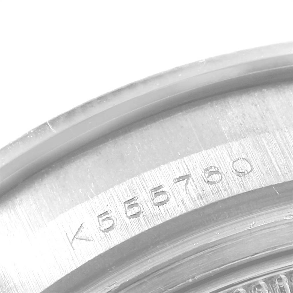 This image shows a close-up angle of the edge of a Rolex Pearlmaster 80299 Women
s White Gold Mother of Pearl Dial 80299 Women
s White Gold Mother of Pearl Dial model watch, focusing on its serial number engraving.